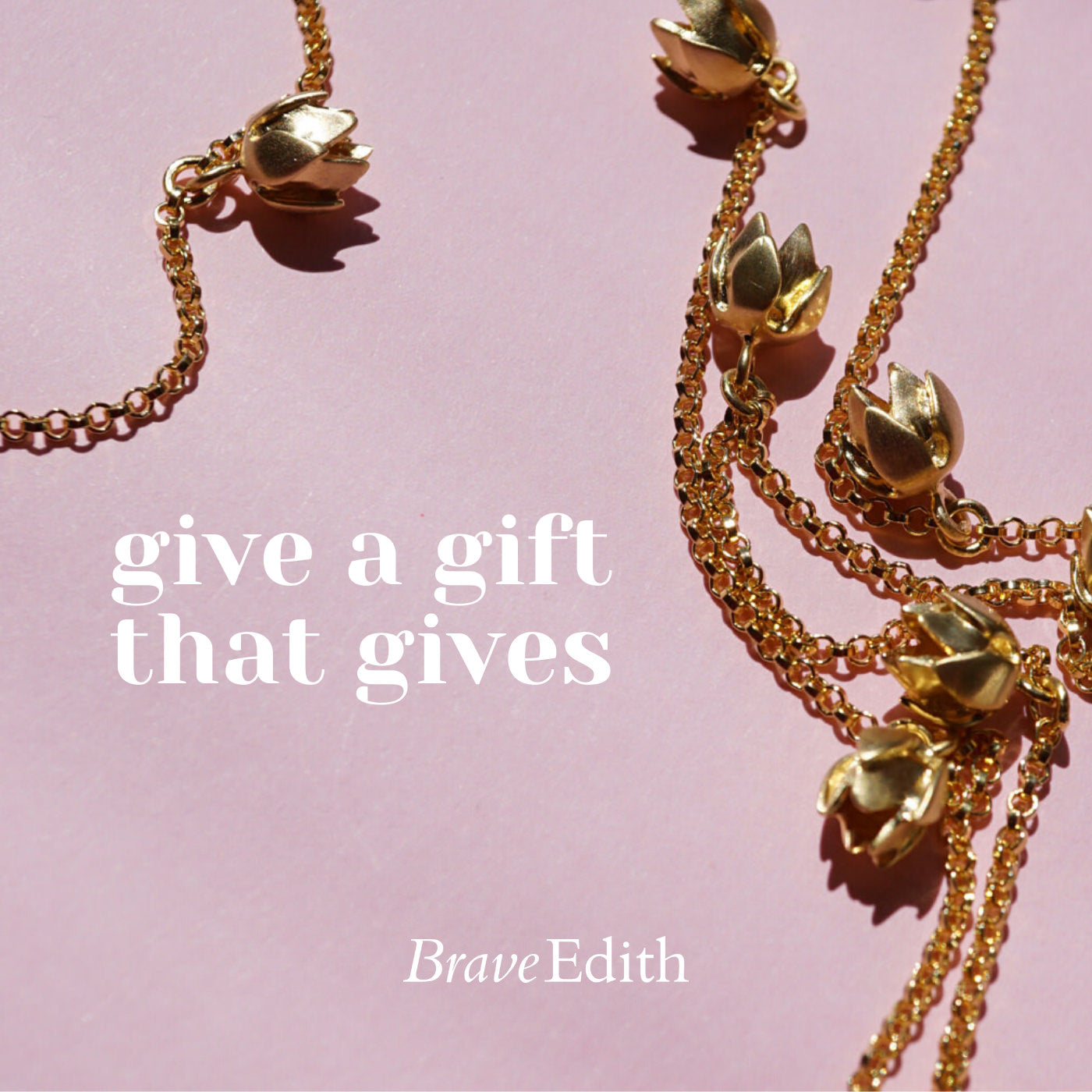 Give a gift that gives gold necklace on pink background