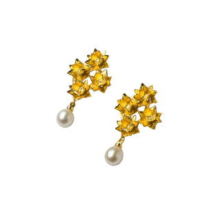 Angle view Gold four lotus pearl earrings on white background