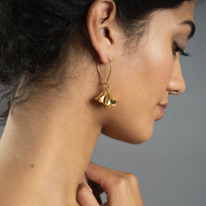 woman wearing gold padauk hook earrings 