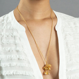 woman wearing large gold padauk necklace 