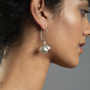 woman wearing silver padauk hook earrings