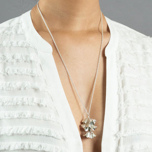 woman wearing large silver padauk necklace