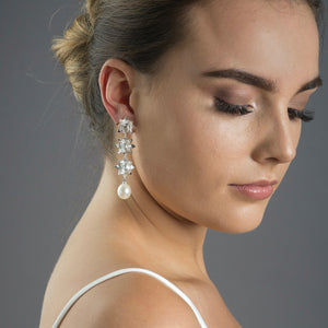woman wearing silver triple lotus pearl earrings