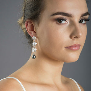 woman wearing silver triple lotus earrings with Tahitian pearls