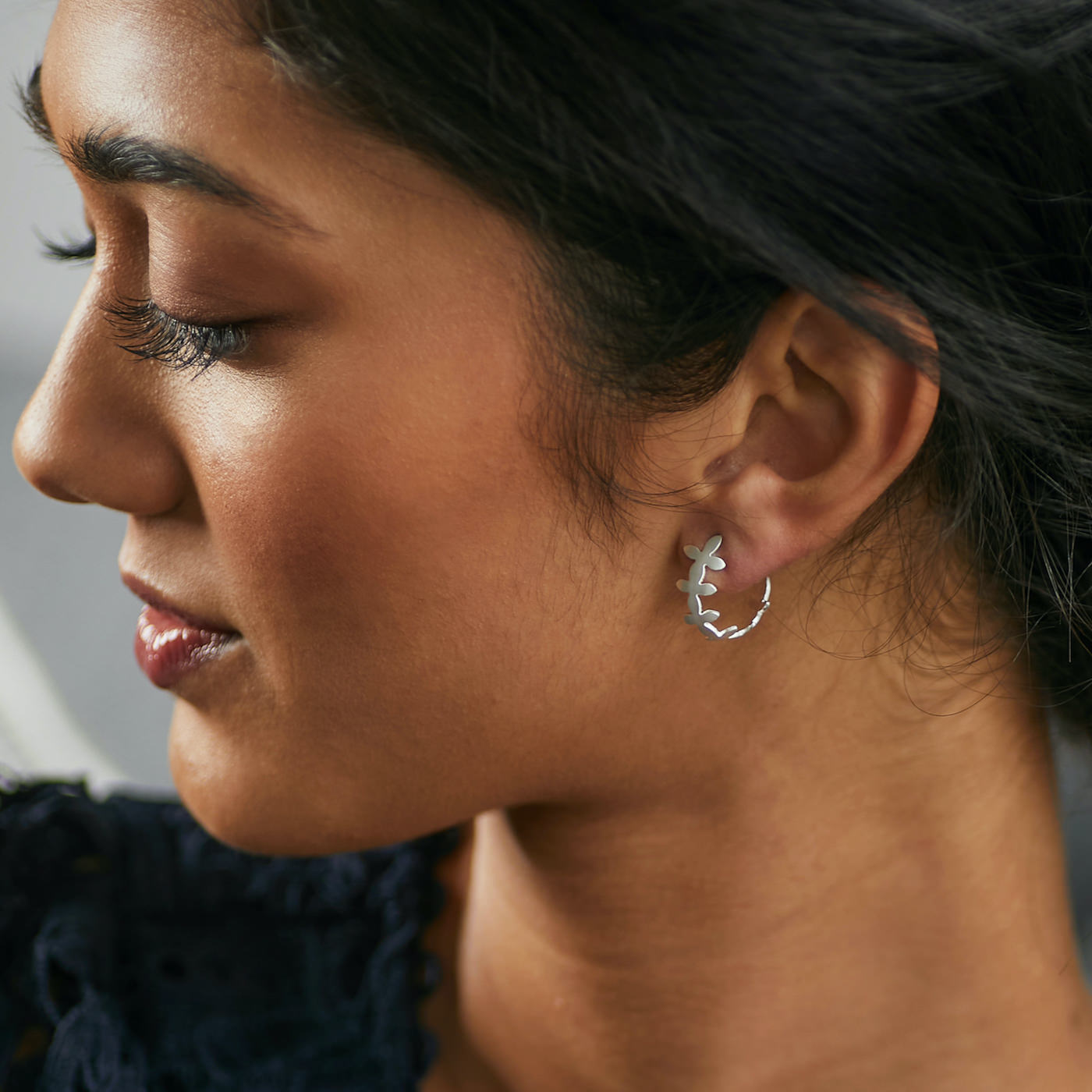 Side view of Brave Edith Thanaka Leaf Small Hoop Studs in sterling silver on white background