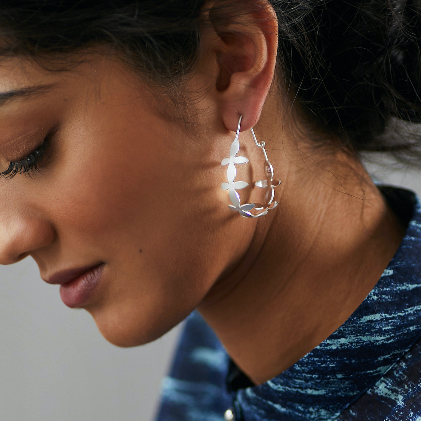 Side view of Brave Edith Thanaka Leaf Teardrop hoops in sterling silver on white background