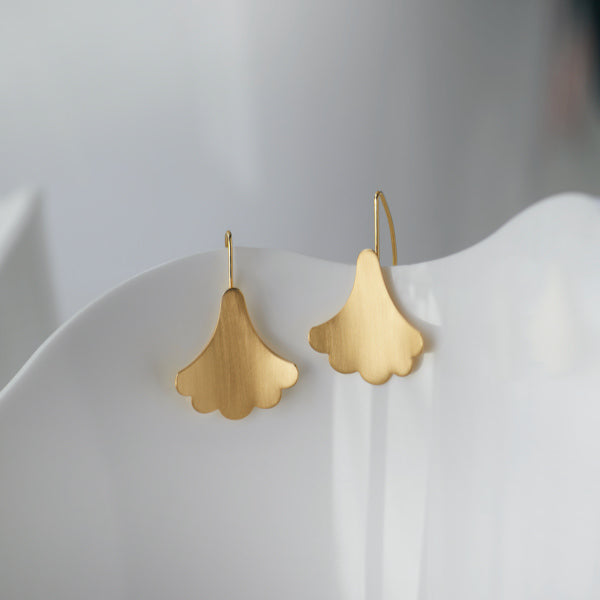 Brave Edith Gold Plume Hook Earrings on White Vase