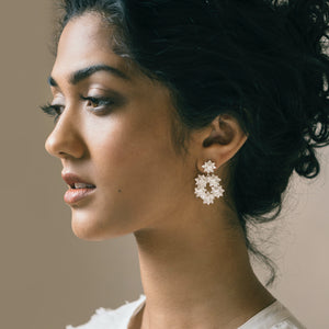 Woman wearing Brave Edith Lotus Wreath earrings in silver