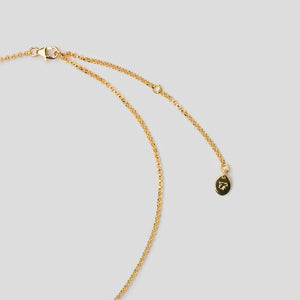 gold clasp of necklace on white background