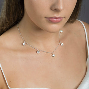 close up of woman wearing silver lotus bud necklace