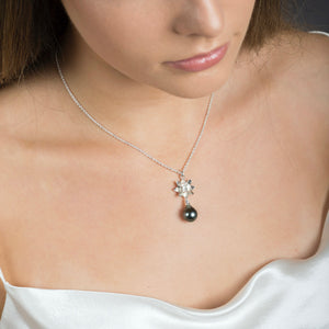 close up of woman wearing silver lotus necklace with Tahitian pearl 
