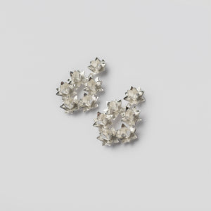 silver lotus wreath earrings on angle on white background