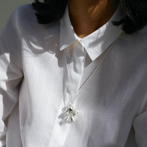 Woman wearing white shirt and Padauk Large necklace in sterling silver by Brave Edith