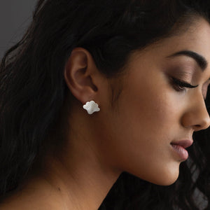 woman wearing silver plume earrings 