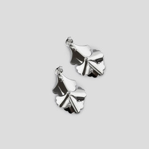 back of silver plume small fan earrings on white background