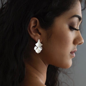 woman wearing silver plume small fan earrings 