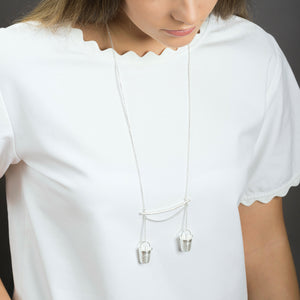 woman wearing silver precious buckets pendant 