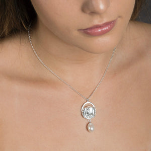woman wearing silver precious elephant pendant 