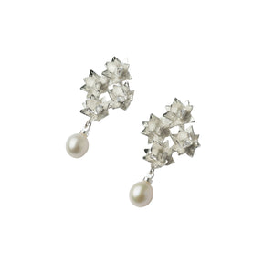 silver four lotus pearl earrings on angle on white background