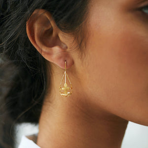 Woman wearing Brave Edith Thanaka Leaf Drop earrings in gold vermeil 