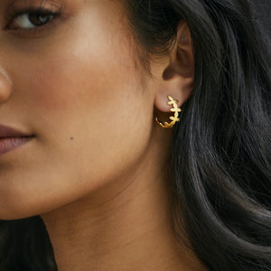 Woman wearing Brave Edith Thanaka Leaf small hoop studs in gold vermeil 