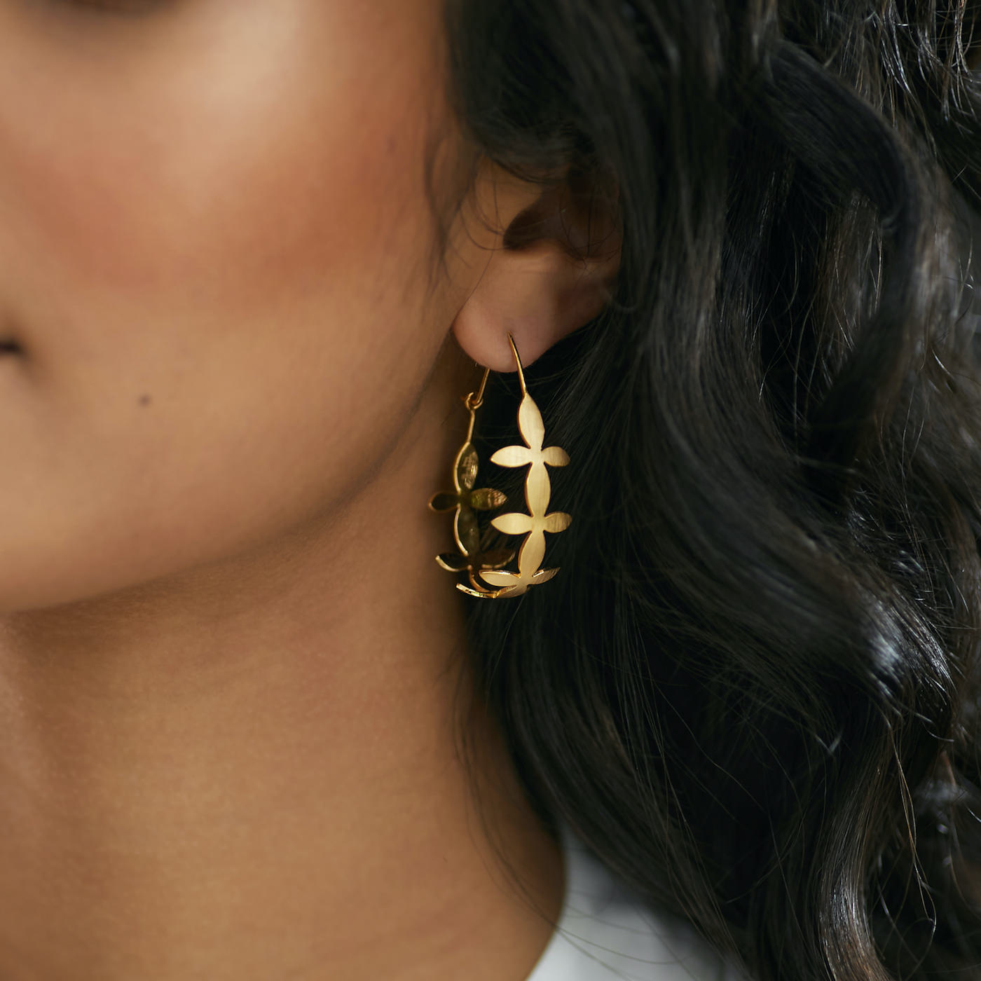 Side view of Brave Edith Thanaka Leaf Teardrop hoops in gold vermeil on white background